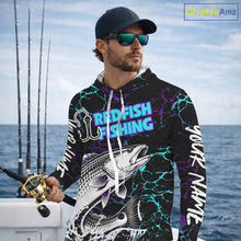 Load image into Gallery viewer, Angler wearing Redfish Fishing neon blue long sleeve hooded saltwater fishing shirt on the boat