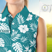 Load image into Gallery viewer, Person wearing a teal shirt with white floral and leaf pattern, blurred background