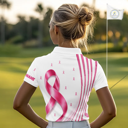 A woman wearing a Breast Cancer Awareness pink ribbon golf polo shirt, standing in the golf course.