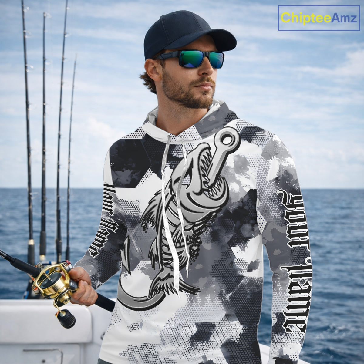 Man wearing personalized fish skeleton long sleeve hooded fishing shirt with custom name on sleeves