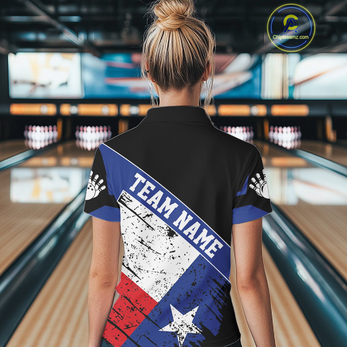 Back view of woman wearing a grunge Texas flag bowling polo shirt inside a bowling alley.