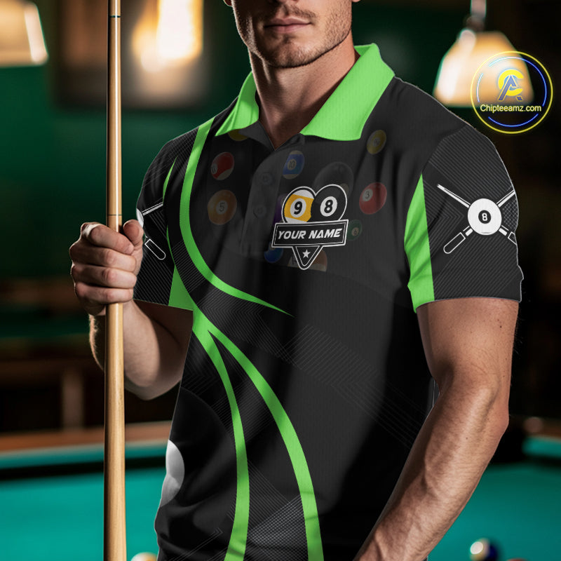 Man wearing a green 8 ball and 9 ball billiard jersey beside a pool table front view.