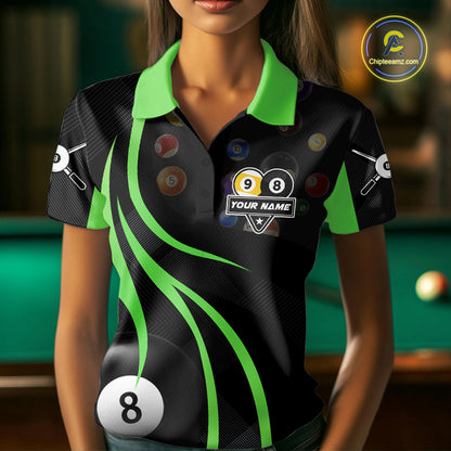 Woman wearing a green 8 ball and 9 ball billiard jersey beside a pool table front view.