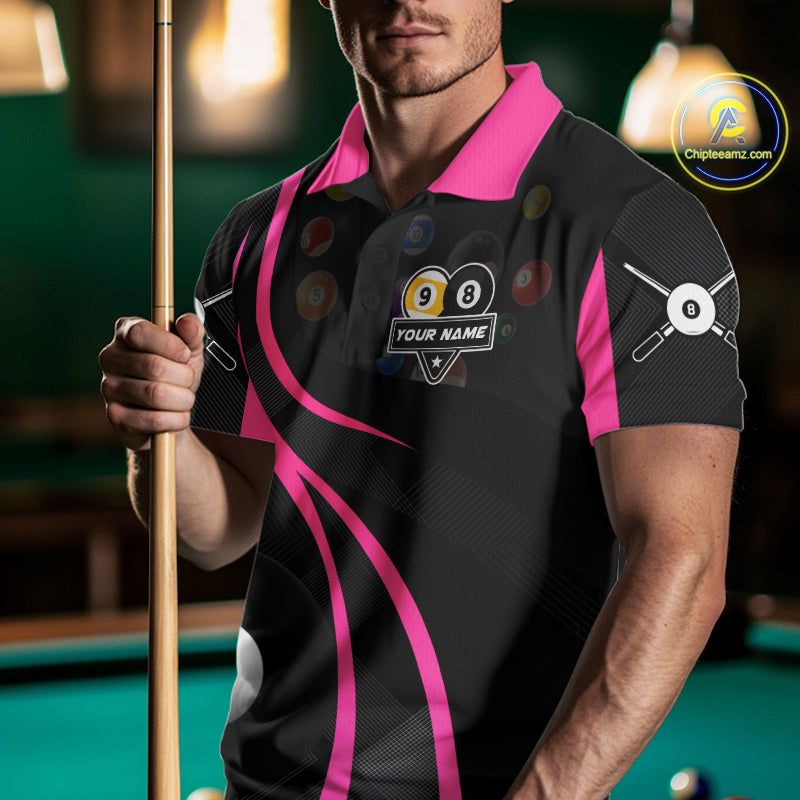 Man wearing a pink 8 ball and 9 ball billiard jersey beside a pool table front view.