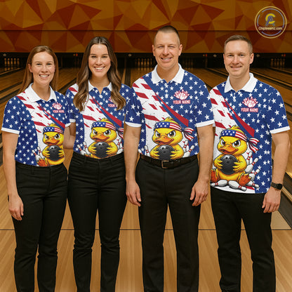 Four people wearing matching American flag-themed shirts with a duck graphic on a bowling alley.