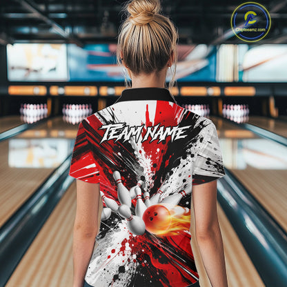 Back view of woman wearing a red splatter bowling polo shirt inside a bowling alley.
