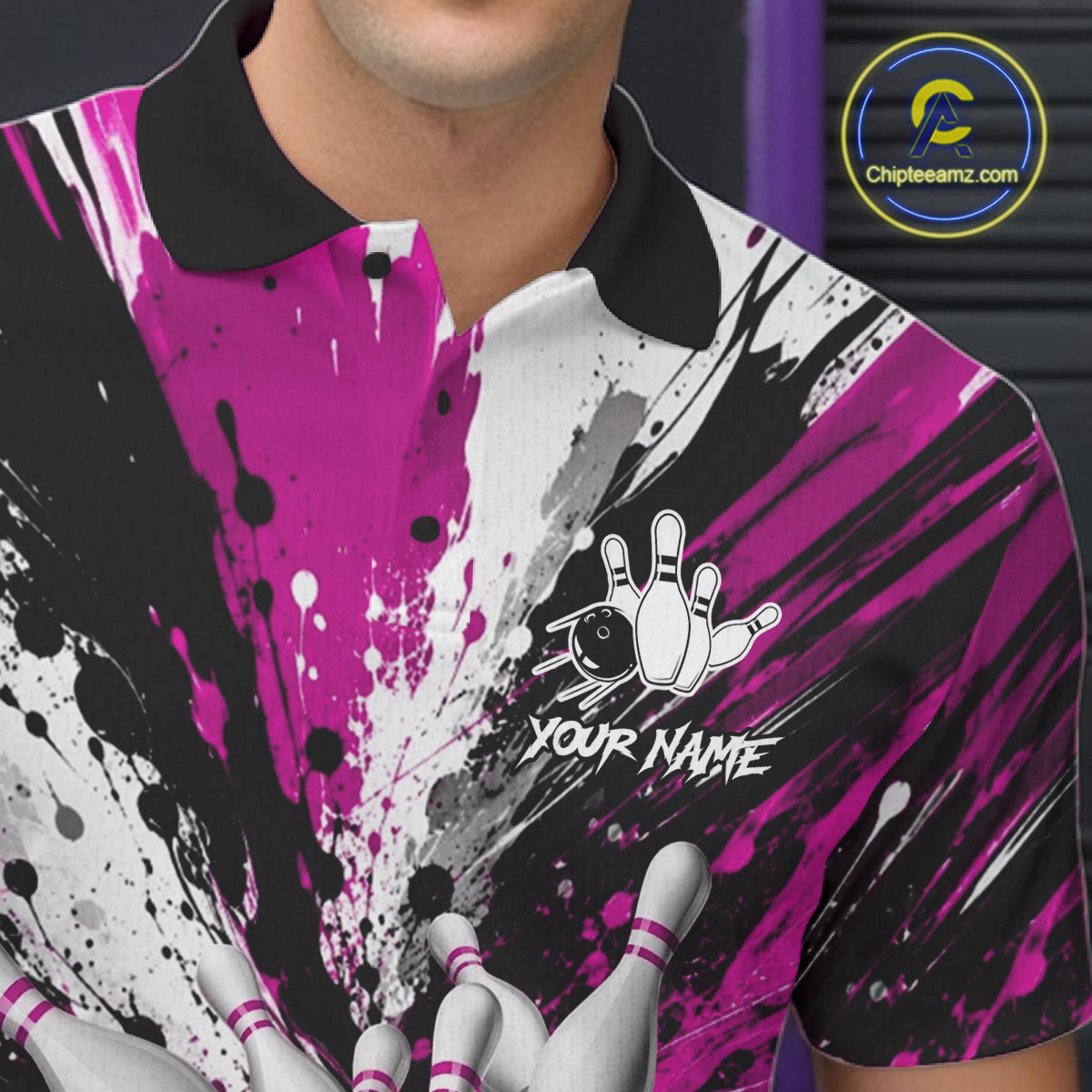 Close-up of a pink splatter bowling polo shirt collar, buttons, and bowling pin artwork.
