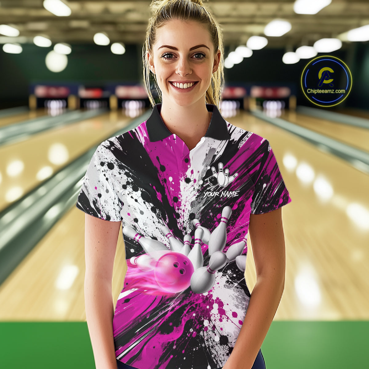 Woman wearing a pink splatter bowling polo shirt at a bowling alley front view.