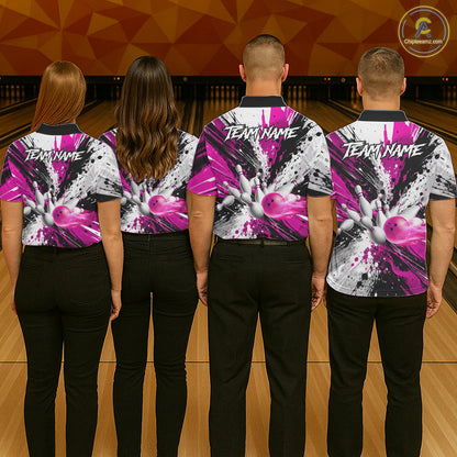Back view of bowling team wearing matching pink splatter bowling shirts in a bowling alley.