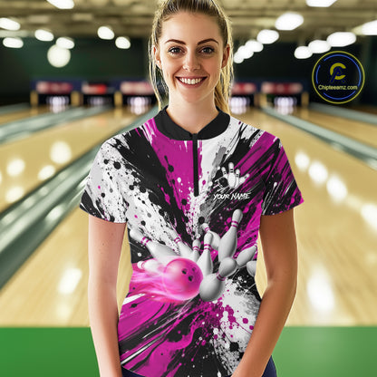 Woman wearing a pink splatter bowling quarter zip jersey during league play front view.