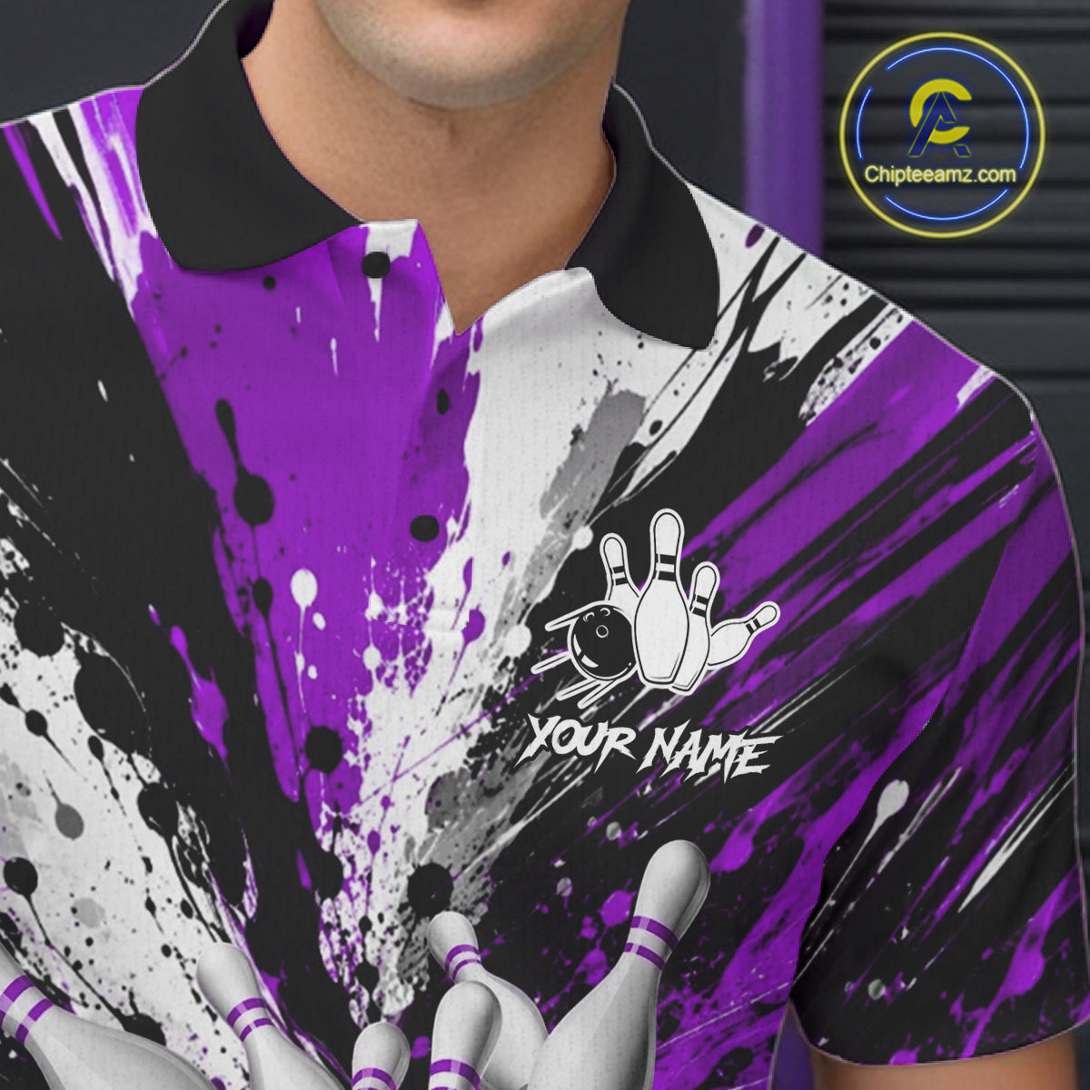 Close-up of a purple splatter bowling polo shirt collar, buttons, and bowling ball graphics.
