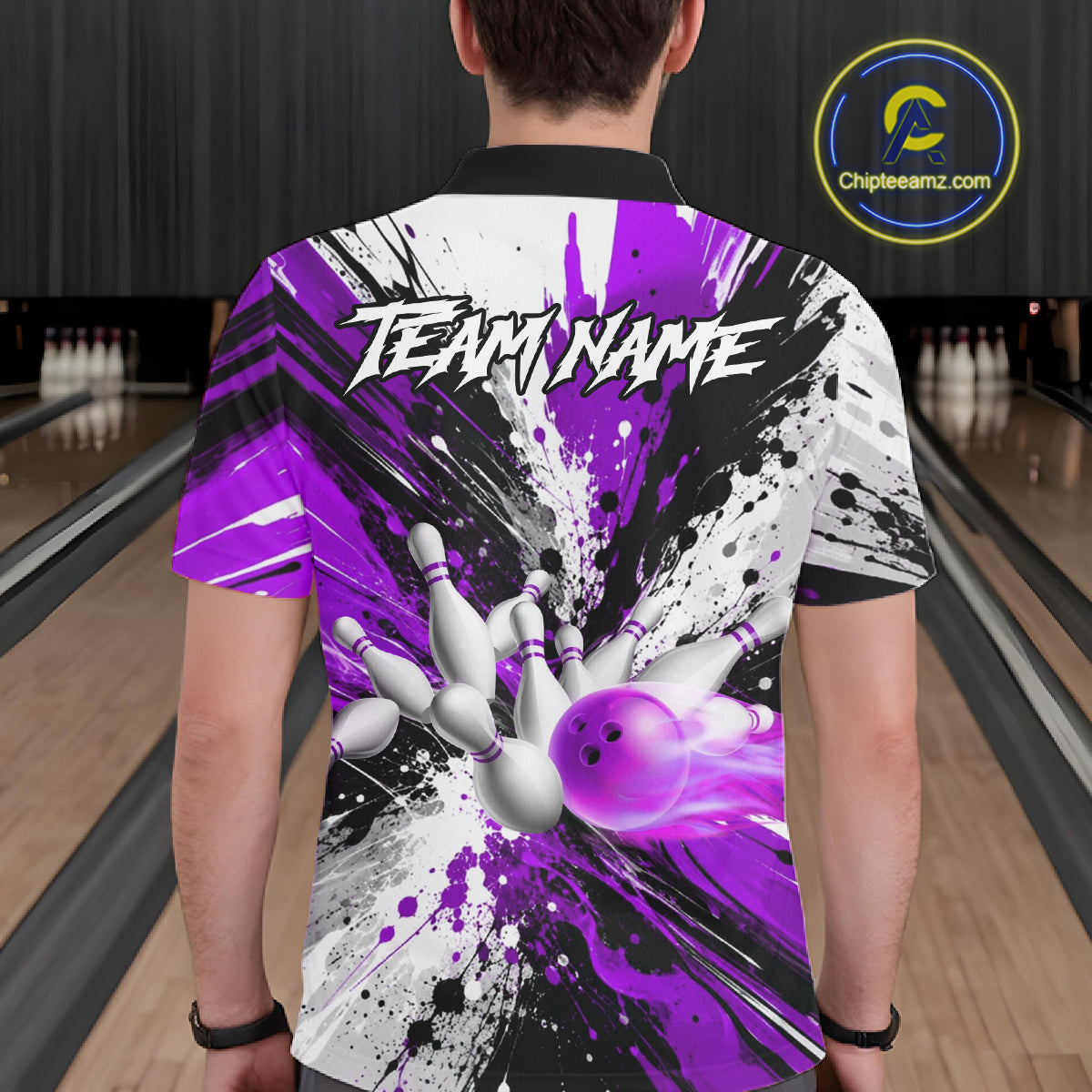 Back view of man wearing a purple splatter bowling polo shirt inside a bowling alley.