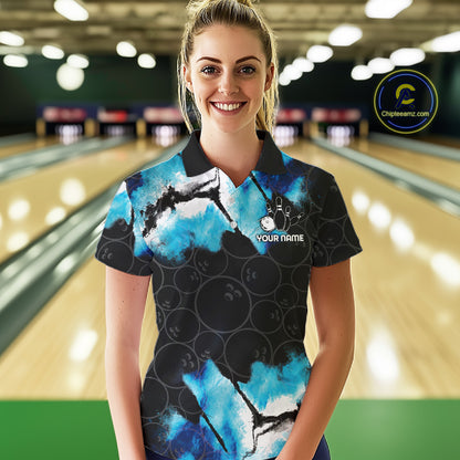 Woman wearing a dreamy blue bowling polo shirt at a bowling alley front view.