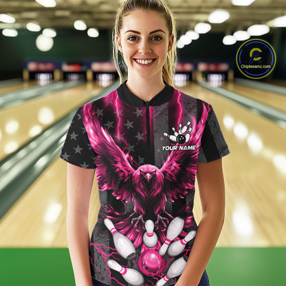 Front view of woman wearing a pink lightning eagle bowling polo shirt inside a bowling alley.