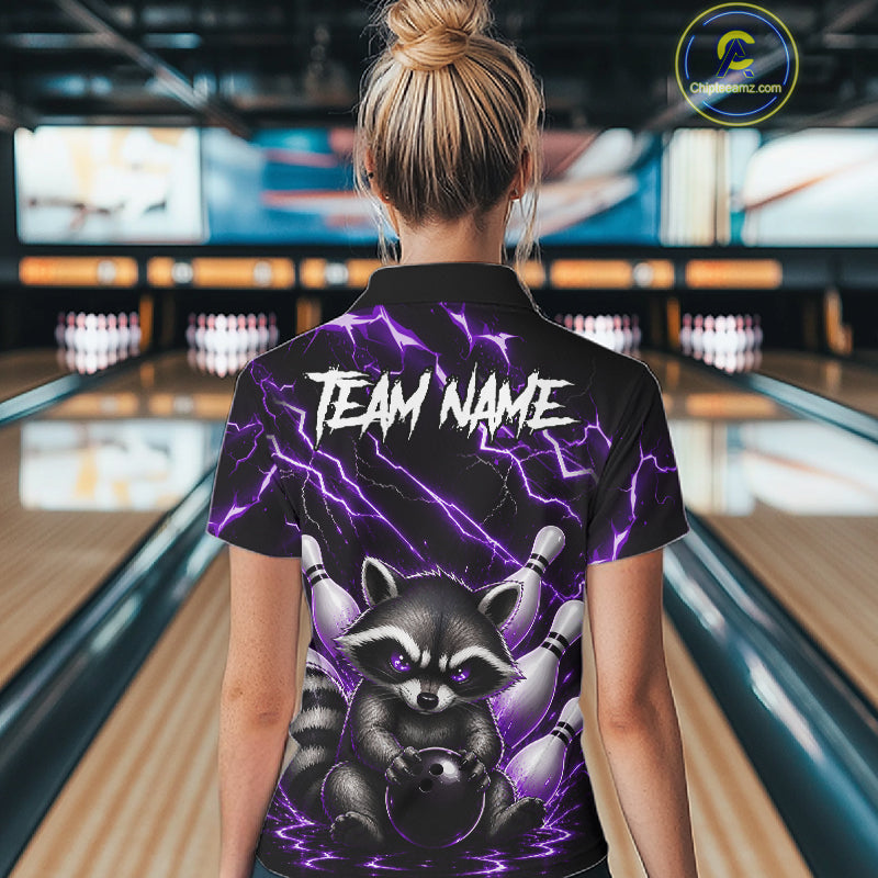 Back view of woman wearing a purple neon lightning raccoon bowling polo shirt inside a bowling alley.