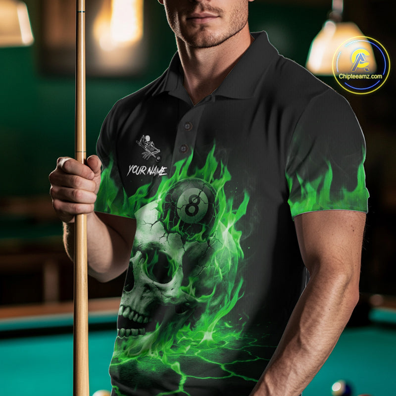 Man wearing a green flaming skull 8 ball billiard jersey beside a pool table front view.
