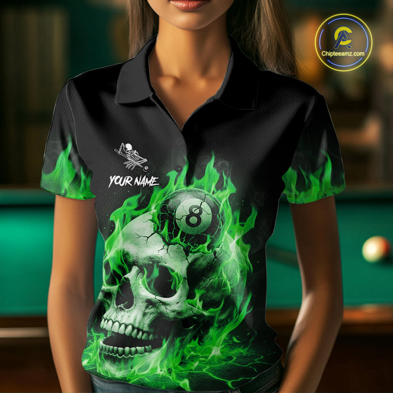 Woman wearing a green flaming skull 8 ball billiard jersey beside a pool table front view.