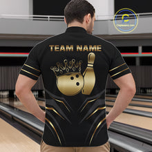 Load image into Gallery viewer, Back view of man wearing a black and gold crown bowling ball quarter zip shirt in a bowling alley.