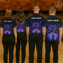 Load image into Gallery viewer, Back view of bowling team wearing matching neon dragon bowling shirts in a bowling alley.