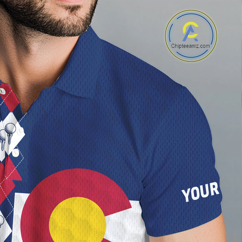 Male golfer wearing Colorado flag golf polo at scenic mountain golf course, perfect for golf vacations, outdoor adventure and state pride.