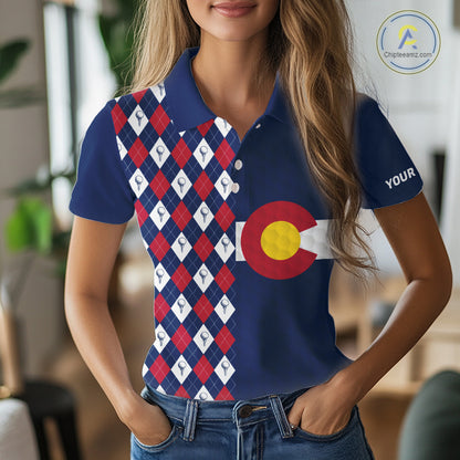 Female golfer wearing Colorado patriotic golf polo at country club, stylish golf apparel for tournaments and mountain golf trips.