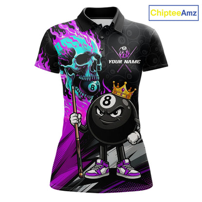 A women's short-sleeve polo shirt with a black base and a vibrant, cartoon-style pool-themed graphic. The design features a skull holding a cue stick with purple and teal flames, a crowned 8-ball character, and the text 'YOUR NAME' on the chest.