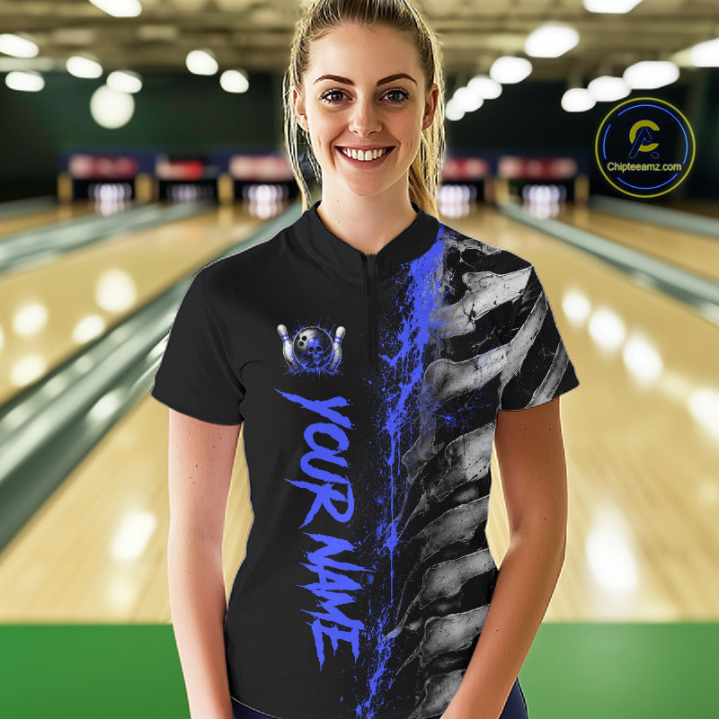 Female model wearing Blue Splatter Grey Bone bowling polo shirt during bowling league competition, skeleton artwork, precision, confidence, athletic lifestyle