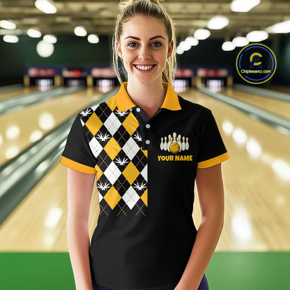 Woman wearing a bowling shirt with a checkered design and logo in a bowling alley.