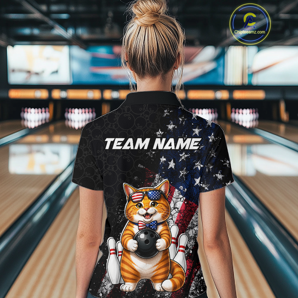 Women wearing a bowling shirt with a cat american flag design and 'TEAM NAME' text in a bowling alley.